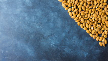 Almonds on a nice blue rustic background. Top view. Copy space. Healthy food concept 