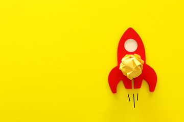 image of red rocket and crumpled paper as idea concept