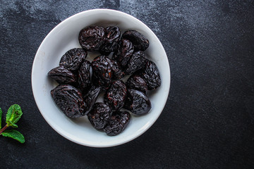 prunes, dried plums (tasty and healthy fruits) desiccated keto or paleo diet
menu concept. background. top view. copy space for text
