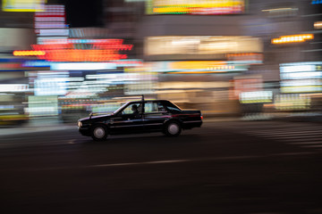 Fototapeta na wymiar Traffic in Namba, Osaka. Taxi in Motion