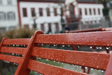 red bench in the rain