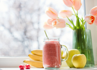 Healthy diet smoothie with strawberry, banana and apples in glass mason jar.