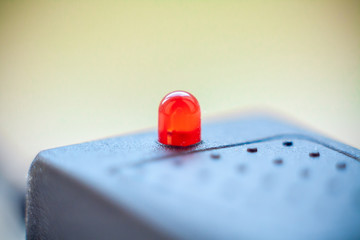 red led on the surface of a black plastic instrument close up