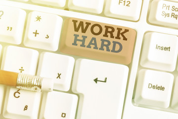 Conceptual hand writing showing Work Hard. Concept meaning Laboring that puts effort into doing and...