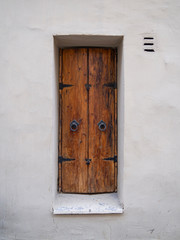 old wooden window shutters on a white wall