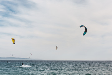 Man is practicing kitesurf on the sea