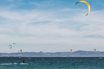 Man is practicing kitesurf in the sea.