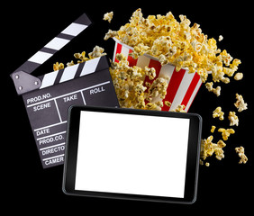 Flying popcorn, film clapper board and phone isolated on black background
