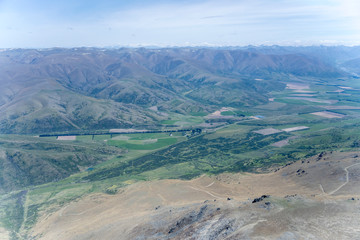 Omarama stream green valley and Ewe range barren slopes, near Omarama, New Zealand