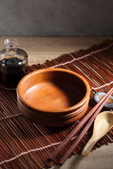 Chopsticks and cup on wooden table, Japanese utensil in rustic backgrounds
