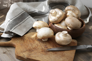 Champignon mushrooms in wood bowl