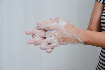 Mom shows daughter proper way to wash hands.