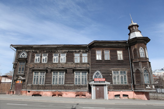 Wooden house with carved windows on Krasnoarmeysky Avenue, 14, in Barnaul city, Russia. Russian, art nouveau style in architecture. Barnaul landmark, Barnaul monument