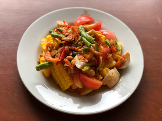 corn Spicy salad with egg in white dish on wooden table.Thai Traditional And Popular Food, Healthy menu, delicious of Thai food