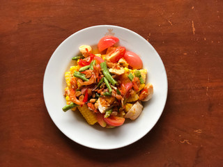 corn Spicy salad with egg in white dish on wooden table.Thai Traditional And Popular Food, Healthy menu, delicious of Thai food
