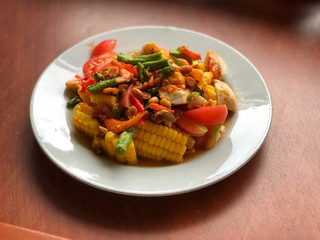 corn Spicy salad with egg in white dish on wooden table.Thai Traditional And Popular Food, Healthy menu, delicious of Thai food
