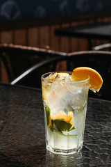 Citrus mojito made from lime and orange. Fresh summer drinks with ice.