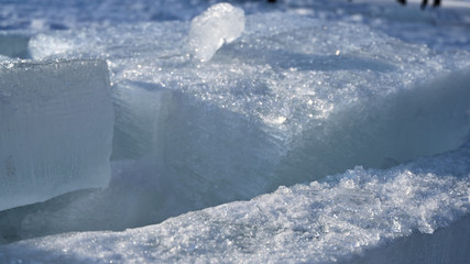 Fototapeta na wymiar broken wall of ice blocks lit by the sun