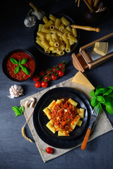 Rigatoni pasta with Bolognese sauce and fresh basil