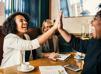 Powerful businesswomen high five