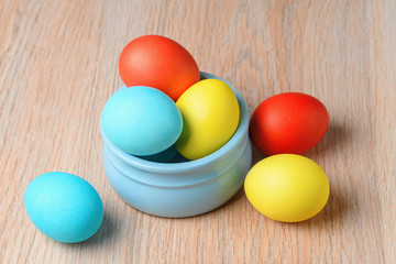 Colorful Easter eggs in a blue bowl. Easter eggs are a symbol and a mandatory attribute of Easter.