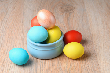 Colorful Easter eggs in a blue bowl. Easter eggs are a symbol and a mandatory attribute of Easter.