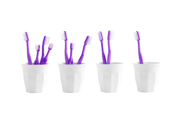 Group of toothbrush in a plastic cup isolated on white background, plastic toothbruch on white background