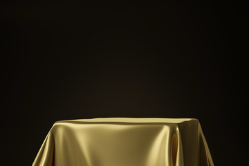 Close up of golden luxurious fabric placed on top pedestal or blank podium shelf on black...