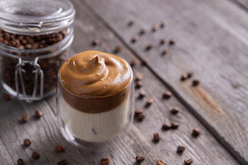 Keto dalgona whipped coffee with milk in a glass