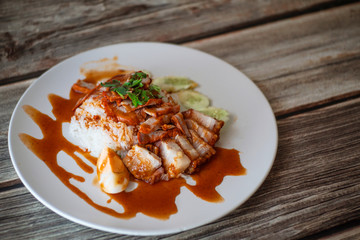 Barbecued red pork and crispy belly pork with sauce and rice.