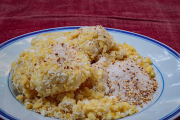 Soft mung bean crepe sprinkled with grated coconut and sugar.