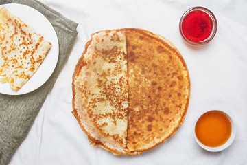 Pancake breakfast. pancakes with honey, maple syrup and jam and a honey dipper. Concept - healthy breakfast, healthy dessert, food photography background, honey dipper, maple syrup