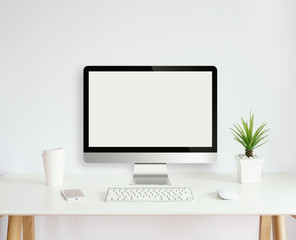 modern computer monitor template mock up on white work desk with blank screen