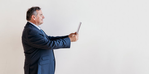 Man taking a photo with a tablet