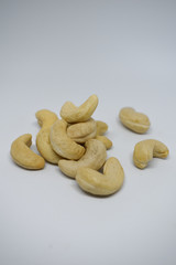 Handful of cashew nuts on a white background, dried fruit