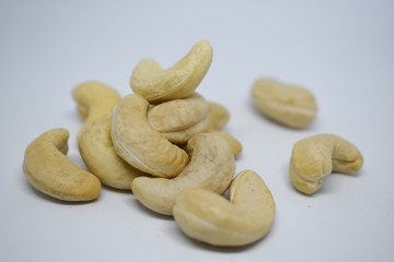 Handful of cashew nuts on a white background, dried fruit