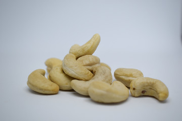 Handful of cashew nuts on a white background, dried fruit