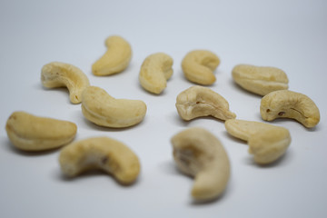 Fototapeta na wymiar Handful of cashew nuts on a white background, dried fruit