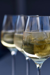 three glasses of fresh delicious german riesling white wine with ice cube