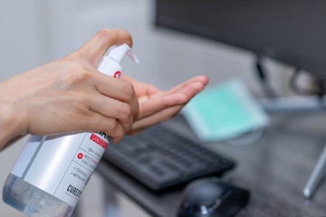 Close up hand woman cleaning her with sanitizer gel,Woman working from home,Woman in quarantine for coronavirus protective,spot focus.