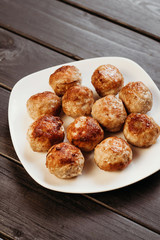 Homemade meatballs fried. Dark background.