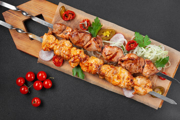Hot grilled chicken shish kebab, with cherry tomatoes,