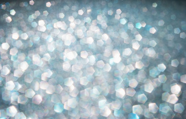 Defocused abstract colorful twinkle light background.  Glittery bright shimmering background use as a design backdrop.