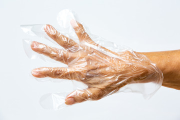 Senior woman's hands wearing disposable protective plastic glove on grey background, Close up shot, Prevention from covid19, Coronavirus, Bacteria, Healthcare