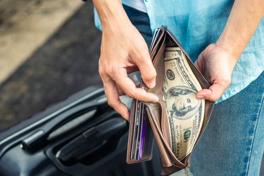 Young woman backpacker traveler hands holding wallet dollar currency money plan to saving spend budget for holiday buy cheap discount deals travel promotion trip after coronavirus empty tourist crisis