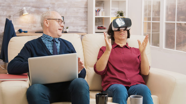 Amazed senior woman while using virtual reality goggles