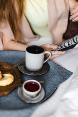 croissant and coffee on the bed in the hotel room