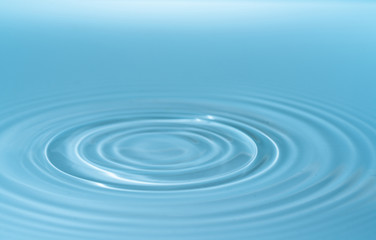 Waves on the surface of the water from a collision. Drop of water drop to the surface.
