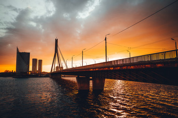 Vansu bridge in Riga cable-stayed bridge  crosses the Daugava river in susnet time