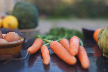 Fresh organic carrots in the foreground with natural light.
